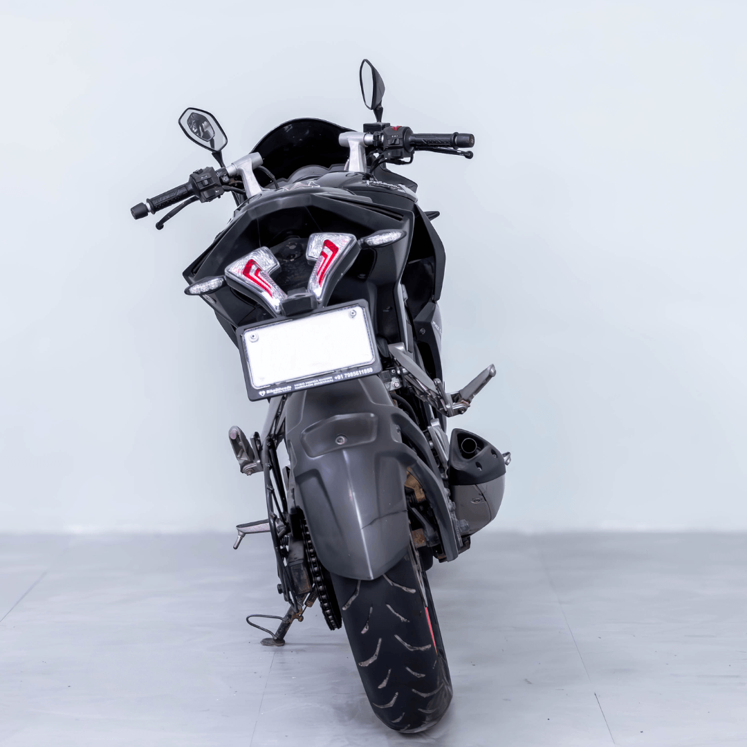 Rear view of Bajaj Pulsar RS 200 showcasing LED tail lights and exhaust design.