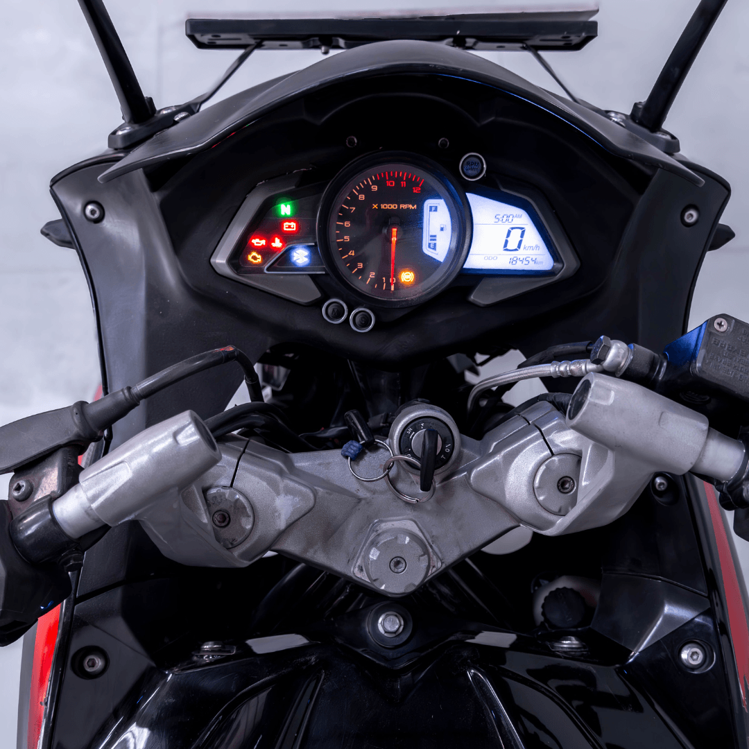 Close-up of Bajaj Pulsar RS 200 digital instrument cluster with speedometer and fuel indicators.