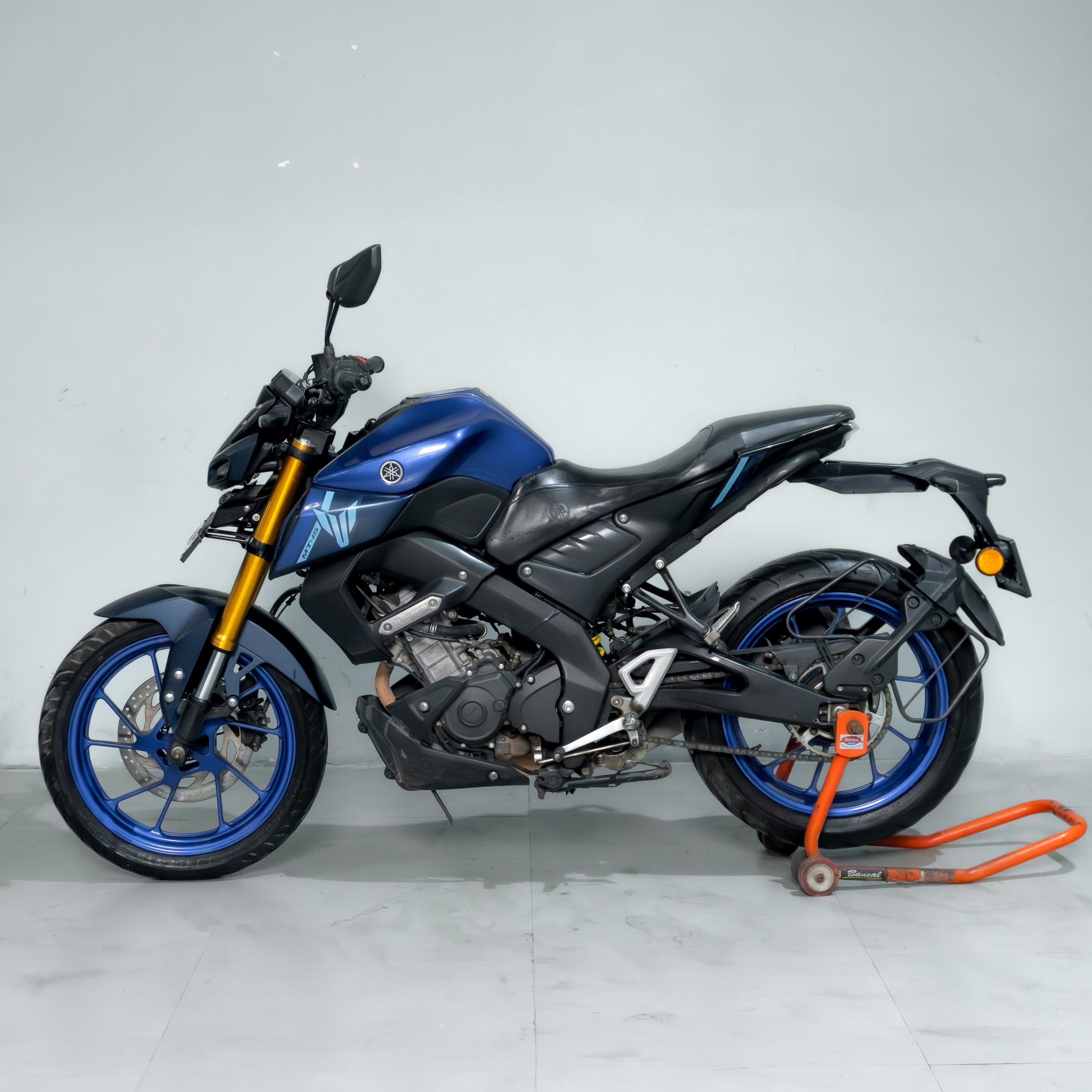 Blue and black motorcycle on a white background