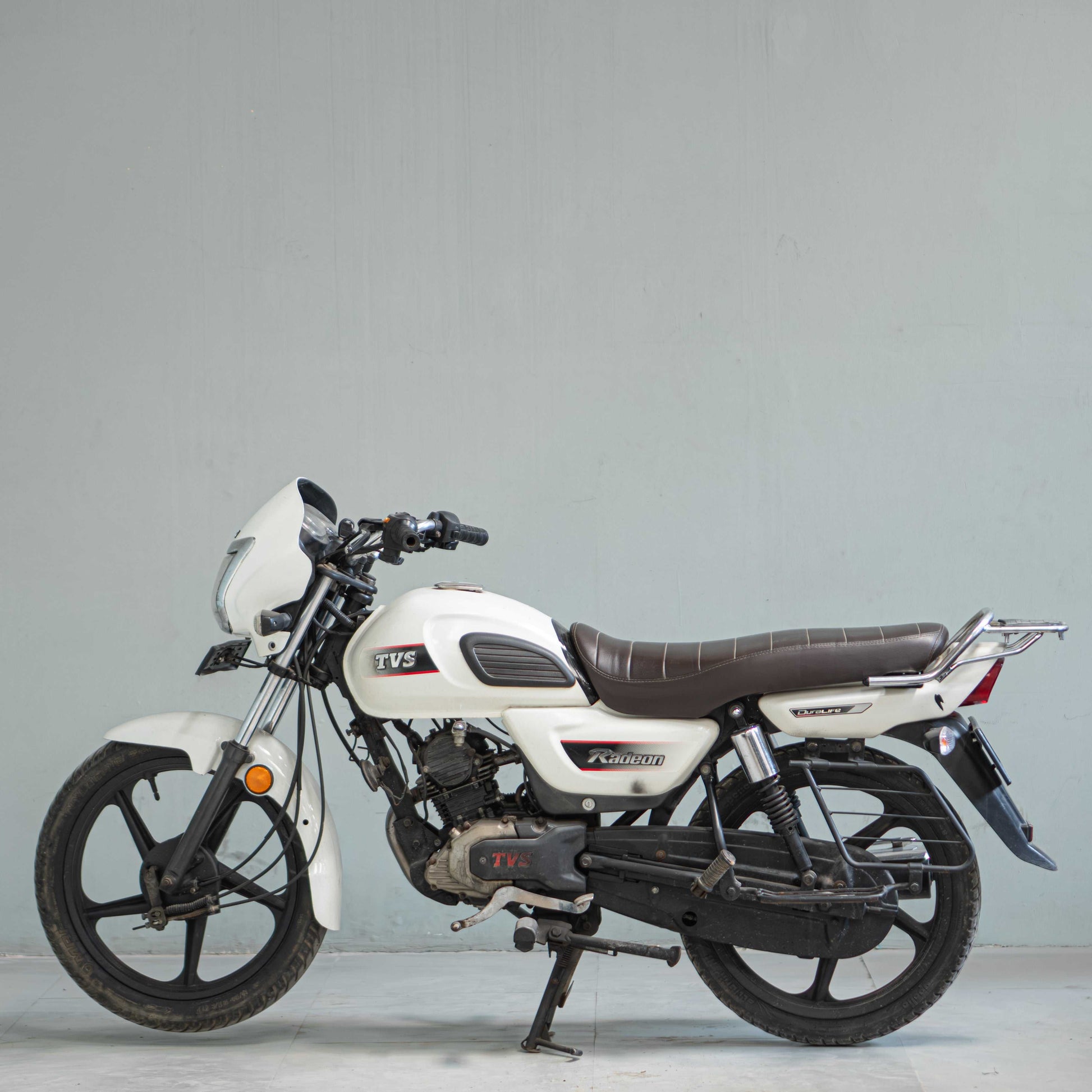 TVS Radeon left side view used bike in Gurgaon white color commuter motorcycle high mileage